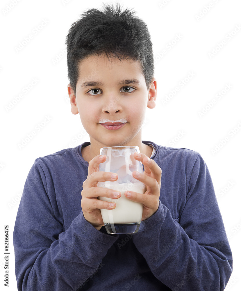 Smiling young boy with milk mustache behind glass of milk Smiling young boy with milk mustache behind glass of milk