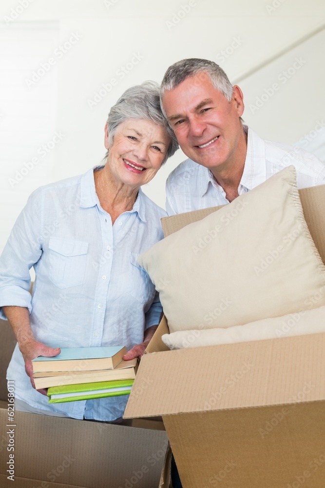 Happy senior couple moving into new home Happy senior couple moving into new home