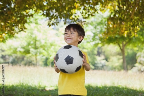Happy cute little boy with football at park © WavebreakMediaMicro