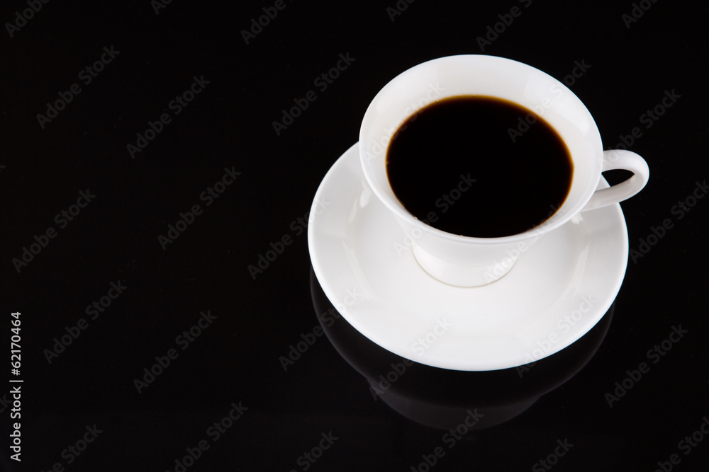 Coffee in a white cup over black background Coffee in a white cup over black background