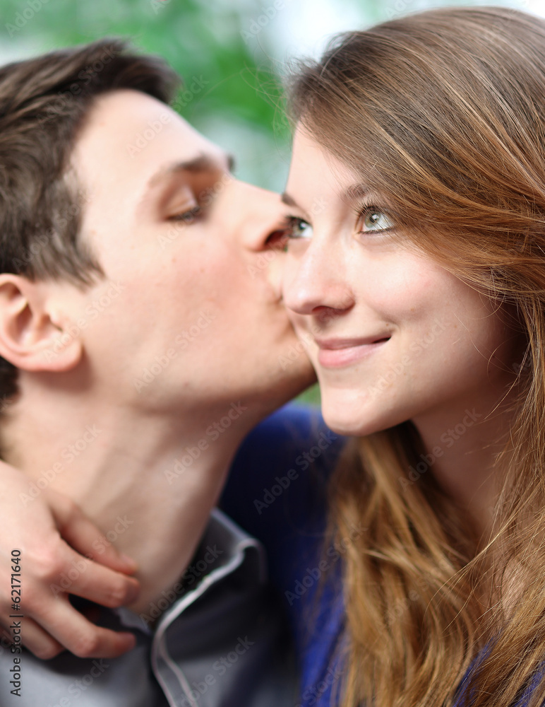 Handsome young man embracing his girlfriend with love Handsome young man embracing his girlfriend with love