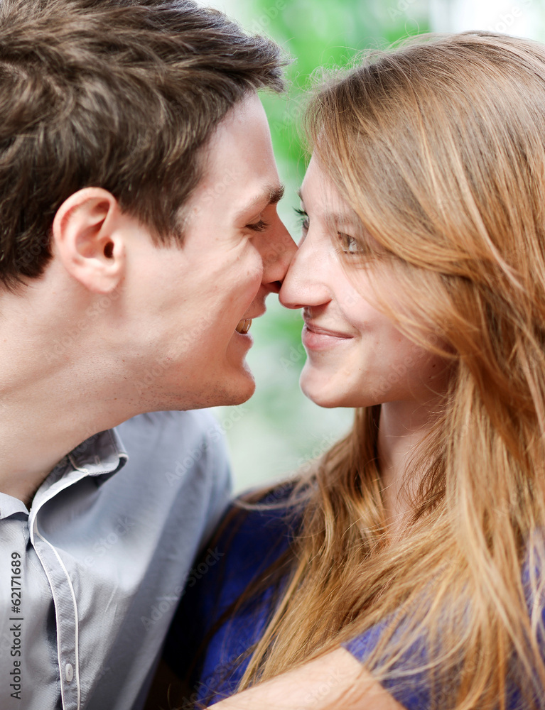 Very attractive young couple flirting on a sofa Very attractive young couple flirting on a sofa