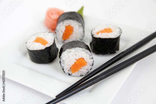 Sushi with rice and carrot on white plate