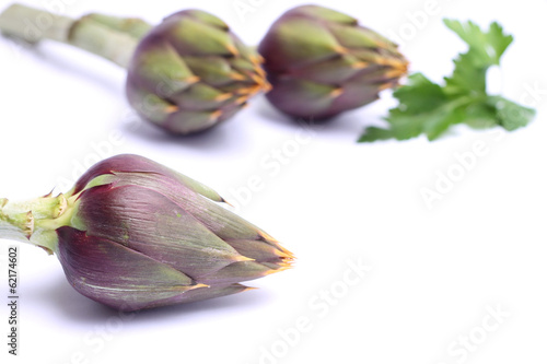 Raw spiny artichokes isolated on white background