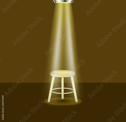 Light shines on empty stool on stage