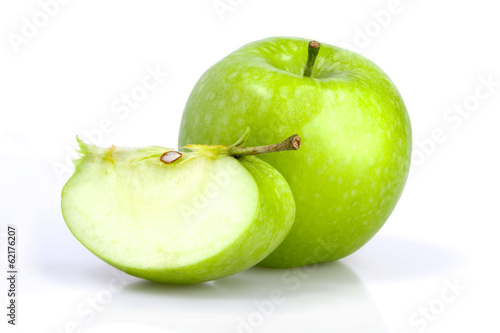 Green apple with a slice on white background