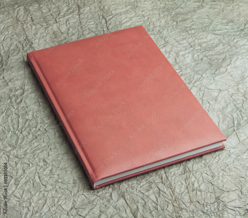Fototapeta premium red books in leather cover on a design paper, identity design,