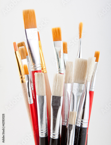 set of colored paintbrushes on a gray background.