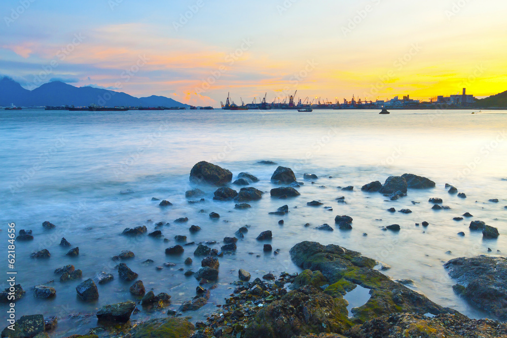 Fototapeta premium Sunset along coast with sea stones