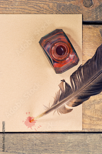 old paper, pen, feather and ink on the table