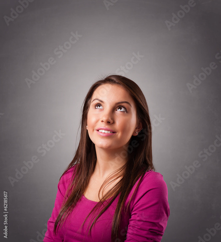 Young woman standing and thinking with copy space