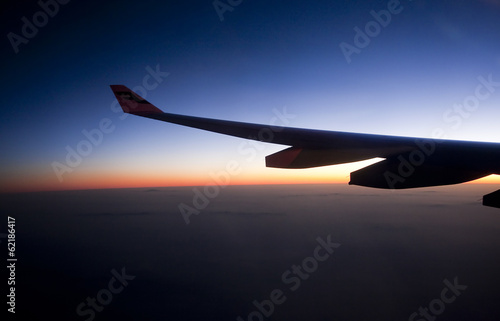 Silhouette of plane wing at sunrise