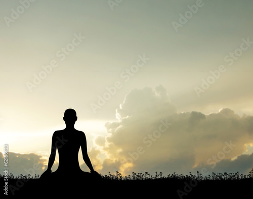 Sunset meditation. Silhouette of a woman doing yoga.