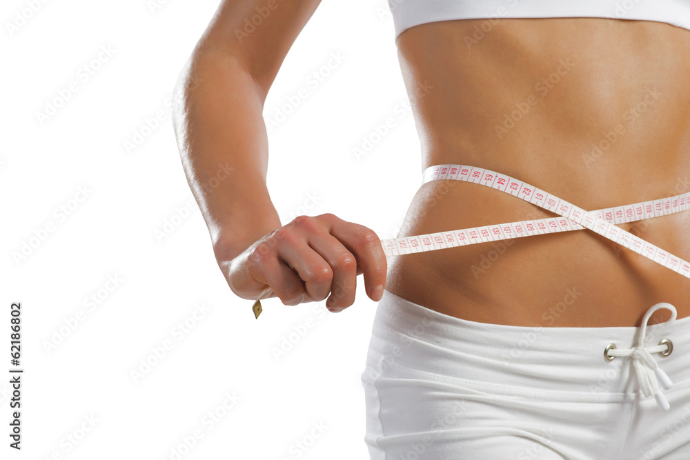 young athletic woman measuring waist young athletic woman measuring waist