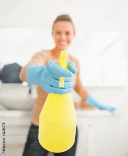 Closeup on housewife showing spray bottle