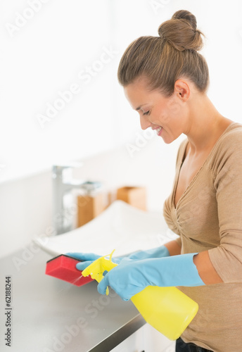 Housewife cleaning in bathroom