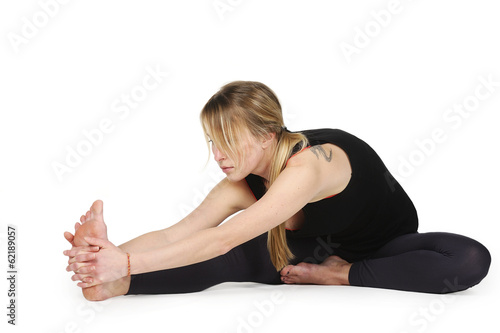 Beautiful young woman in great shape practicing yoga