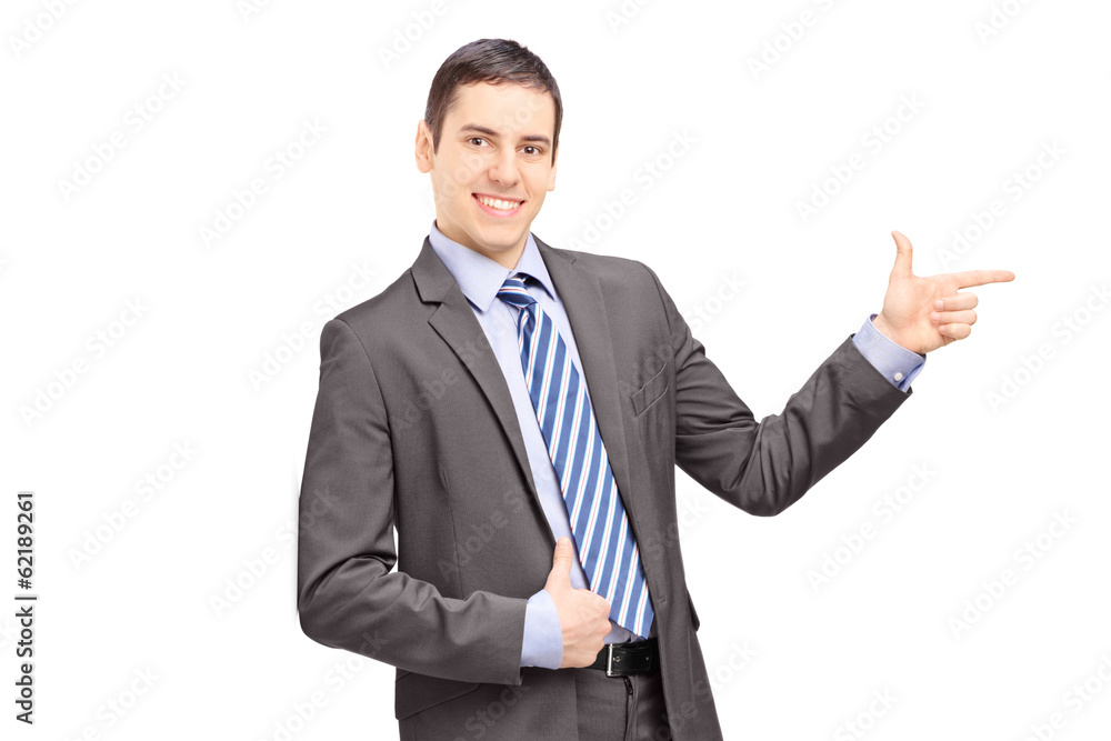 Businessman leaning against wall and pointing Businessman leaning against wall and pointing
