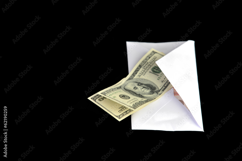 Dollar bills in white envelope isolated on black background Dollar bills in white envelope isolated on black background