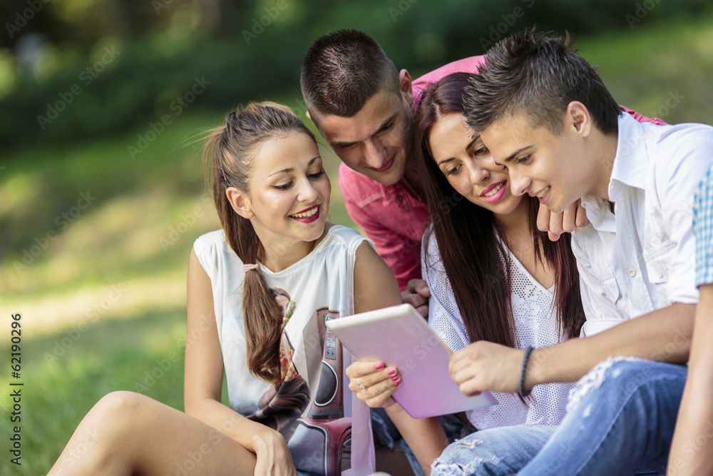 Teenagers in the park with tablet Teenagers in the park with tablet