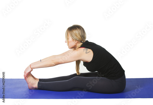 Beautiful young woman in great shape practicing yoga