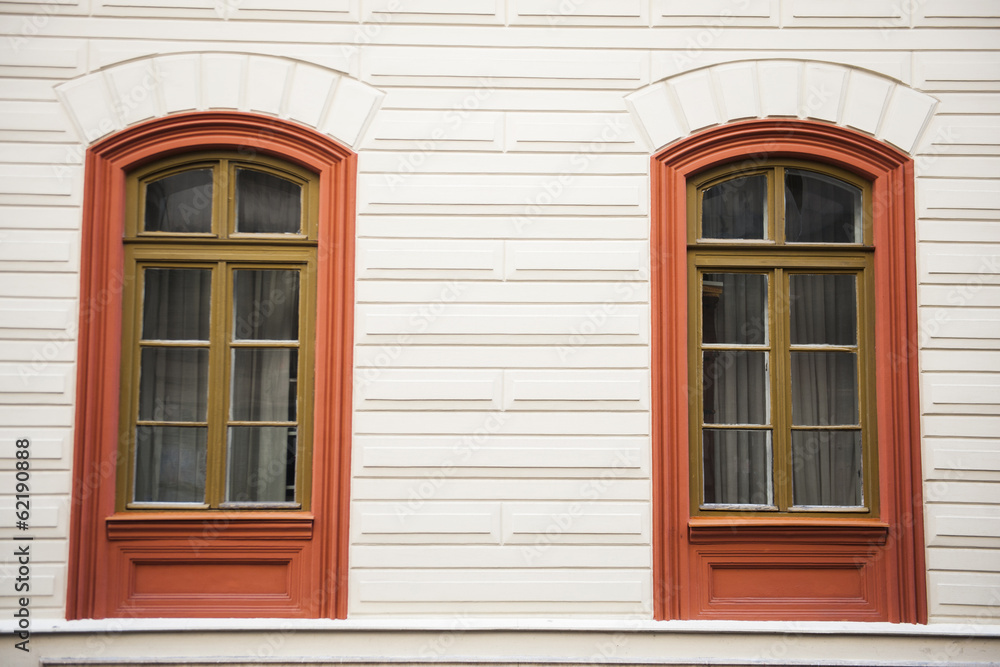 Two window red frames on a facade Two window red frames on a facade