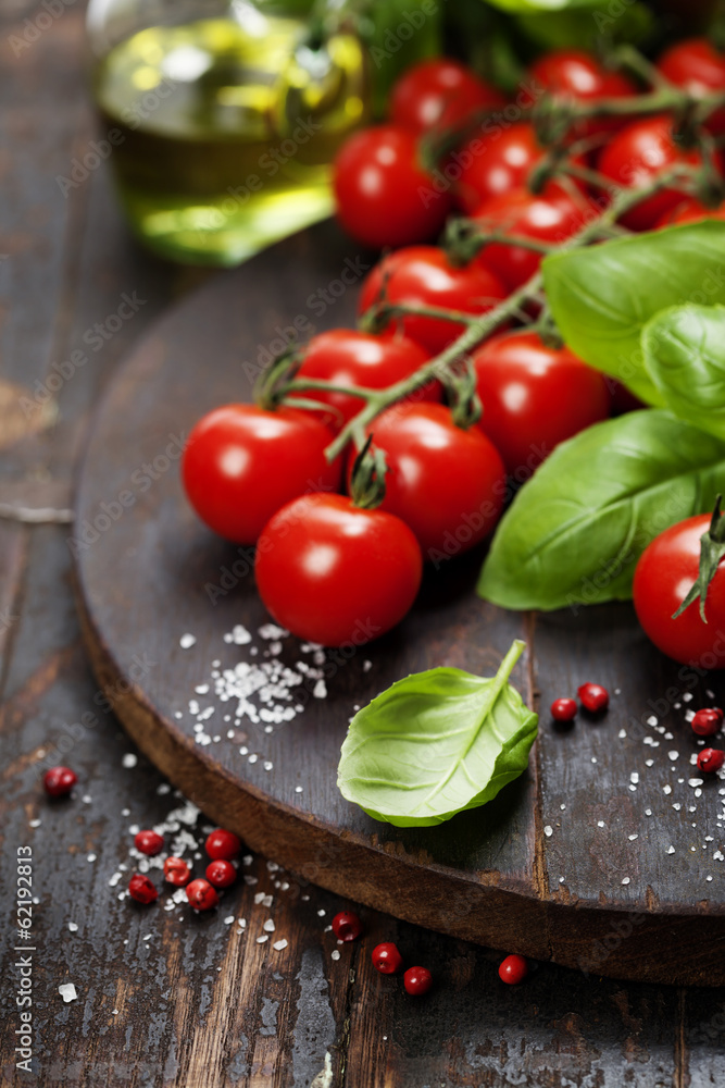 Tomatoes with basil on wooden table background Tomatoes with basil on wooden table background