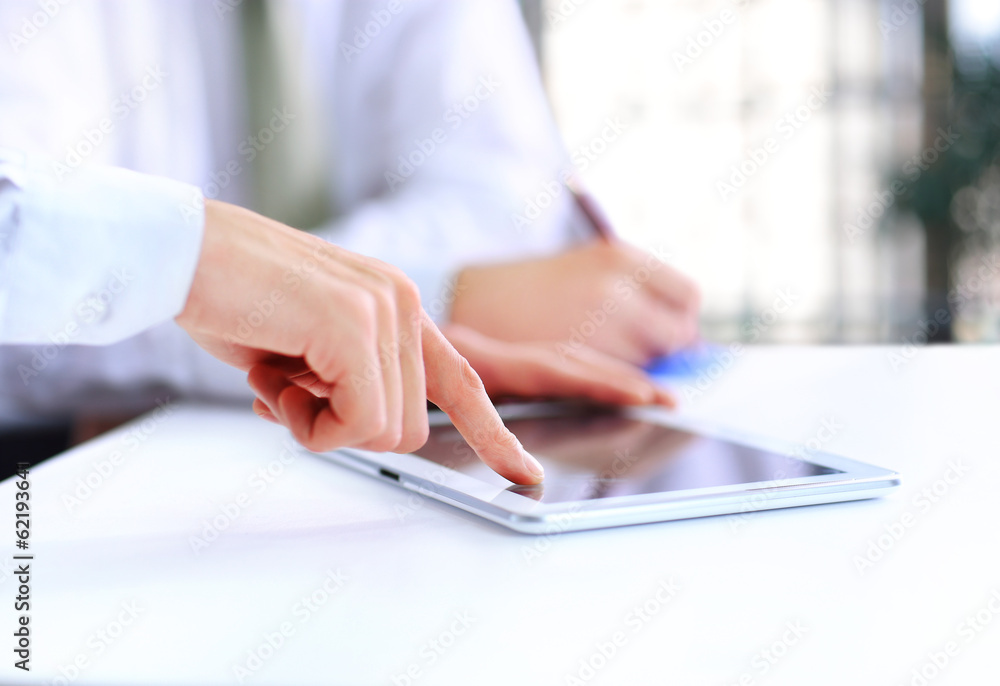Close-up of a modern business team using tablet Close-up of a modern business team using tablet