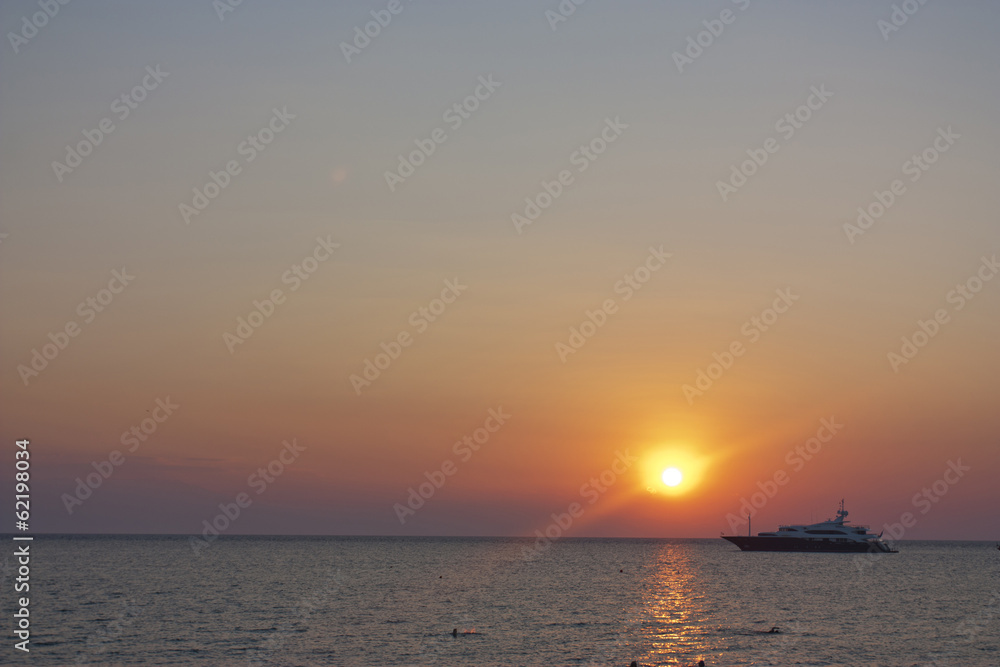 sunset with a yacht moored in the sea sunset with a yacht moored in the sea