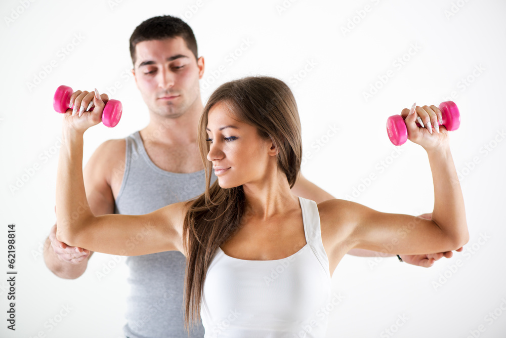 Personal trainer assisting a client Personal trainer assisting a client