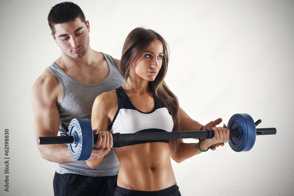Personal trainer assisting a client Personal trainer assisting a client
