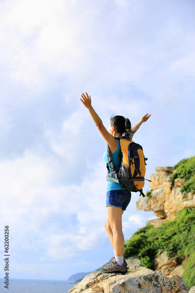cheering woman hiker open arms at mountain peak cheering woman hiker open arms at mountain peak