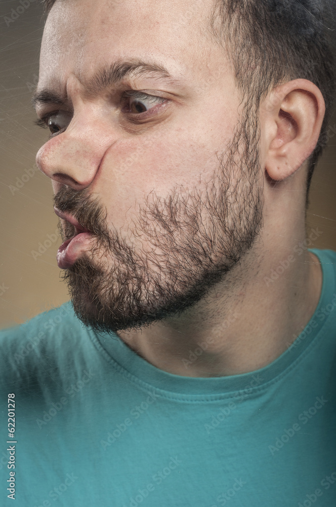 Obraz premium Funny Faces - Man Blowing Against the Glass Surface