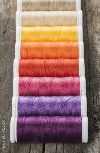 Single row made of color spools of sewing threads