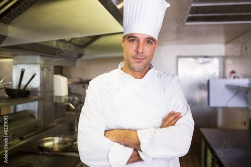 Male cook with arms crossed standing in kitchen