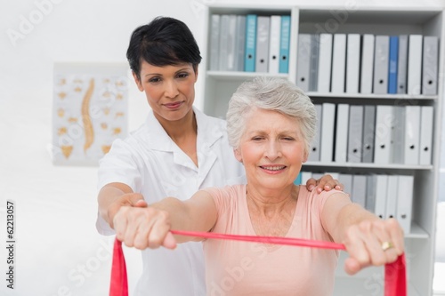 Female physiotherapist massaging senior womans back