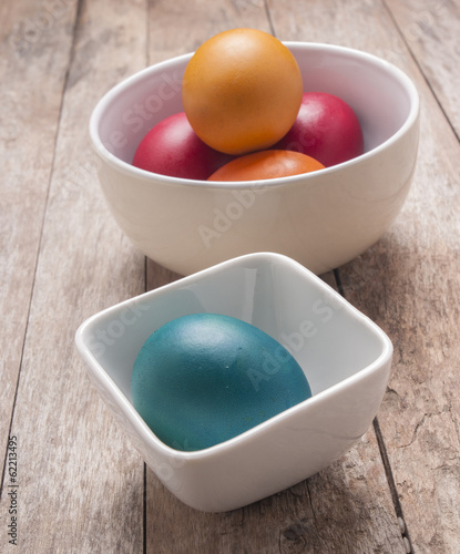 Colorful easter eggs on wooden background