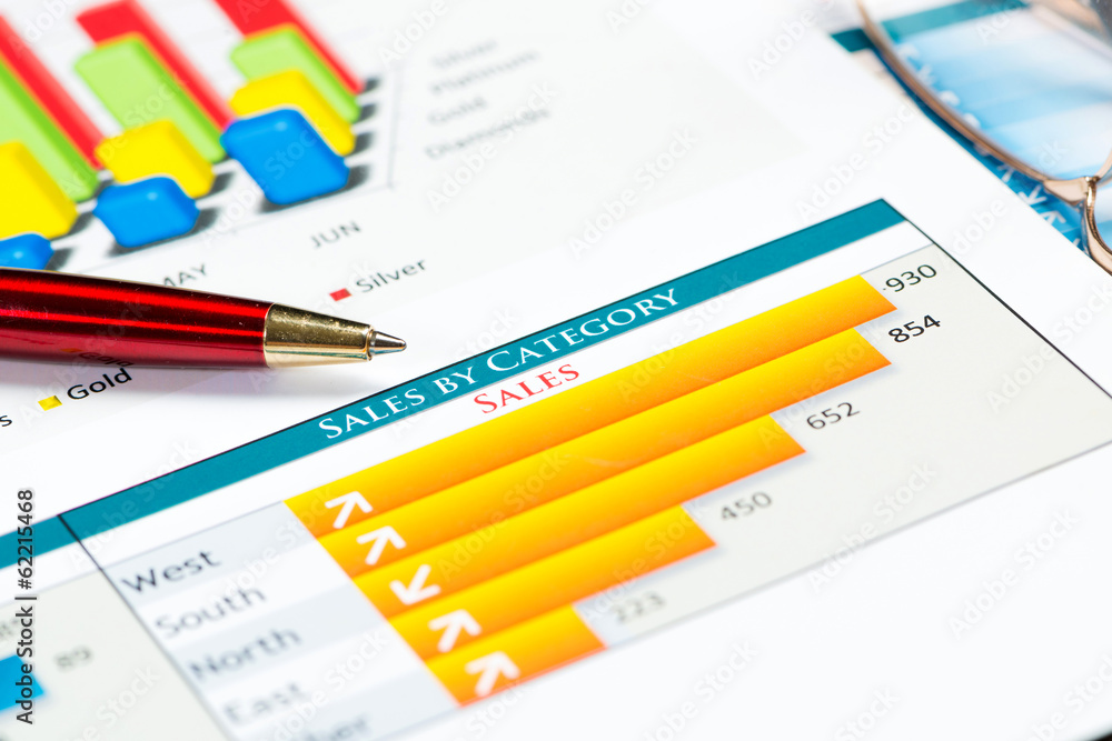 close-up of pen and financial growth charts close-up of pen and financial growth charts