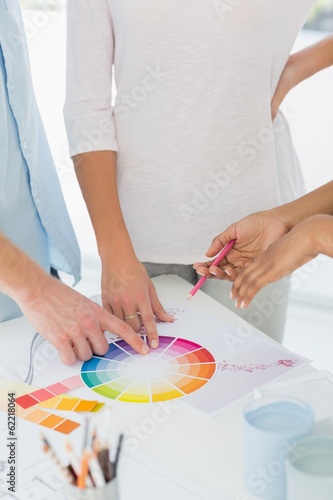 Interior designer showing colour wheel to two customers