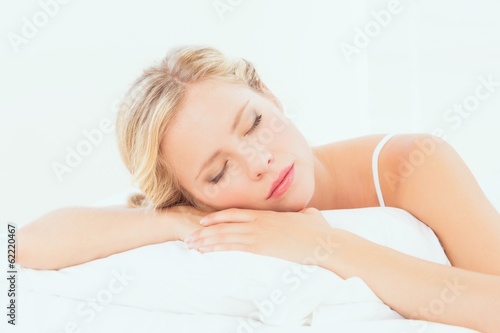 Peaceful young blonde sleeping on her bed