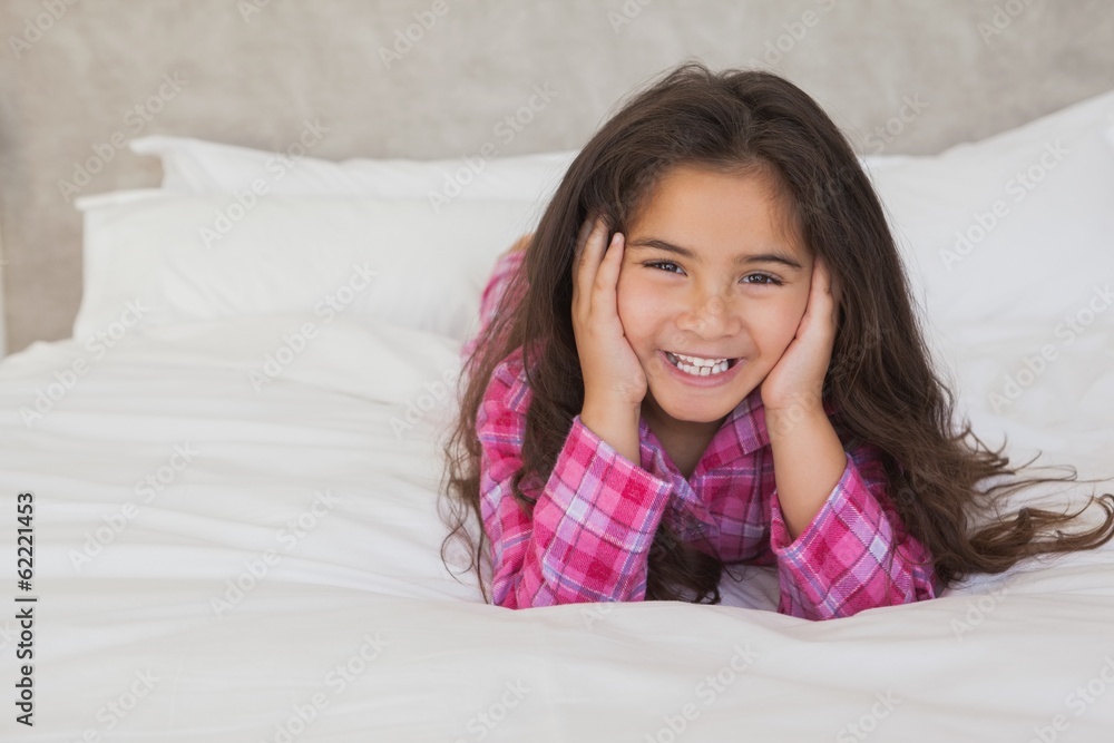 Portrait of a smiling girl lying in bed Portrait of a smiling girl lying in bed