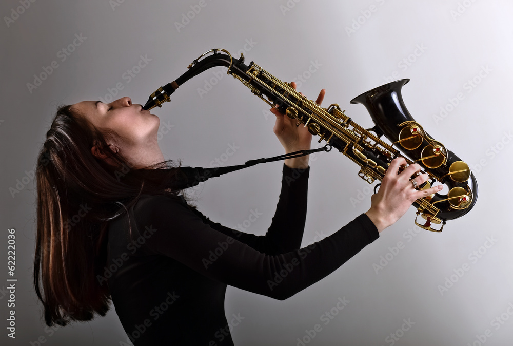 Naklejka premium woman in black with saxophone