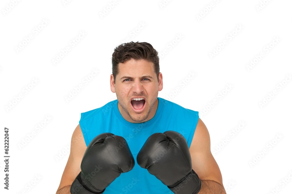 Close-up portrait of a determined male boxer screaming