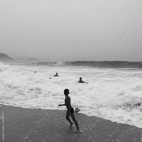 a boy plays with ball on copacabana beach Rio de Janeiro, Brazil