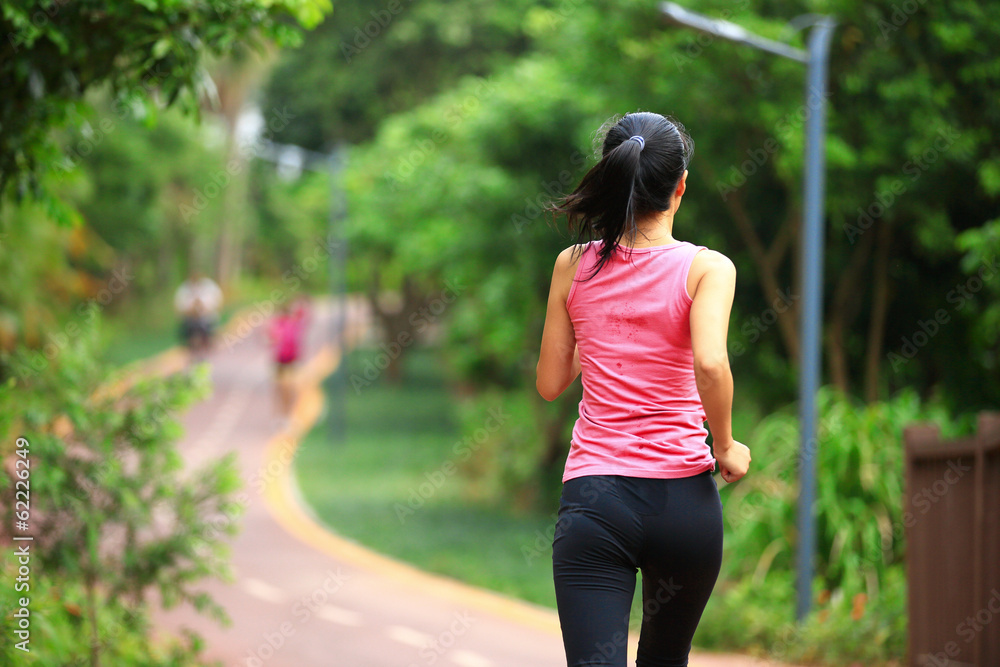 fitness woman runner running at park trail
