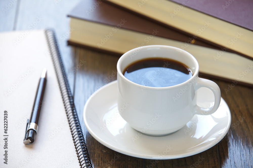 Coffee break at work Coffee cup on a pile of books Coffee break at work Coffee cup on a pile of books
