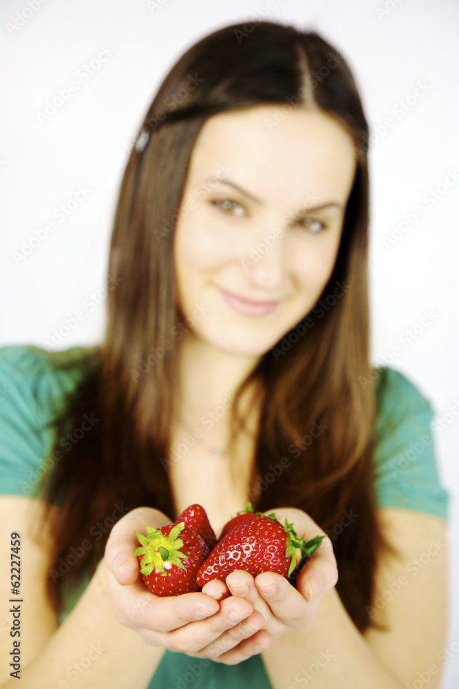 Closeup of fresh strawberries in hands of female model Closeup of fresh strawberries in hands of female model
