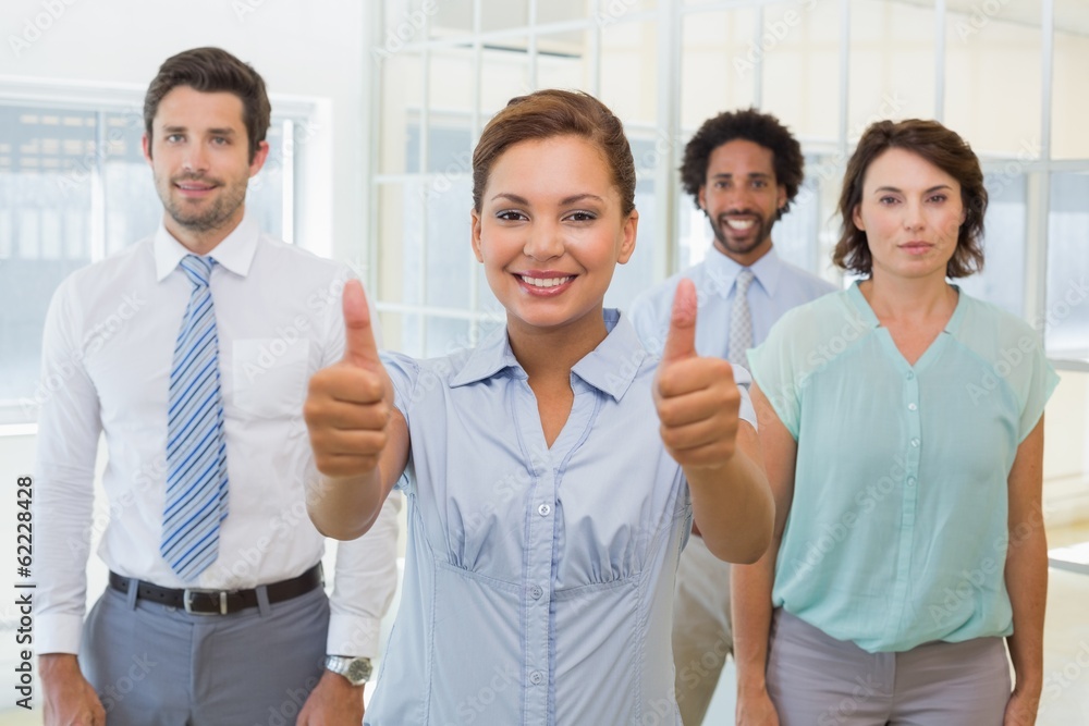 Businesswoman with colleagues gesturing thumbs up Businesswoman with colleagues gesturing thumbs up