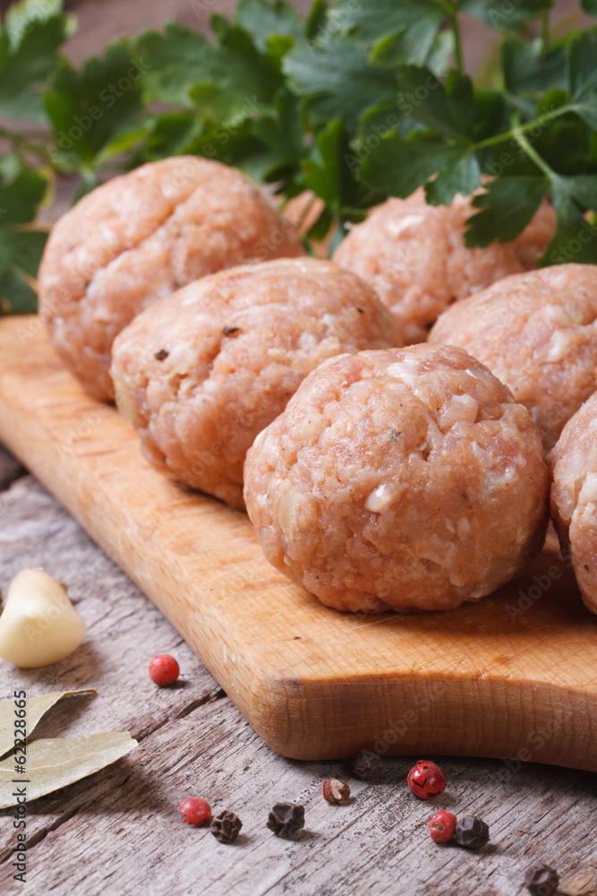 raw meatballs on a chopping board vertical raw meatballs on a chopping board vertical