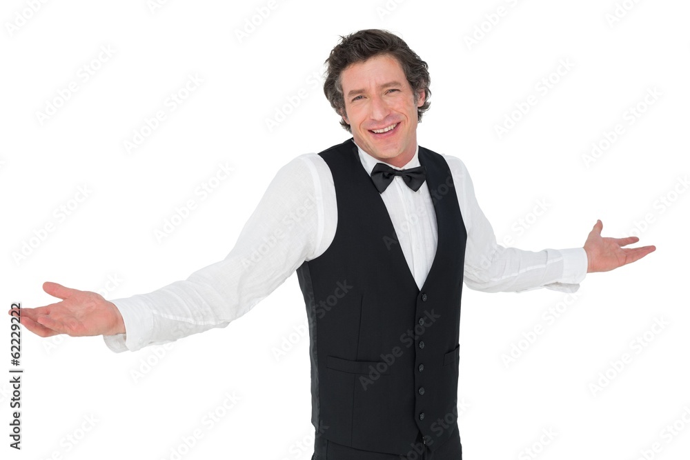 Smiling waiter shrugging over white background Smiling waiter shrugging over white background